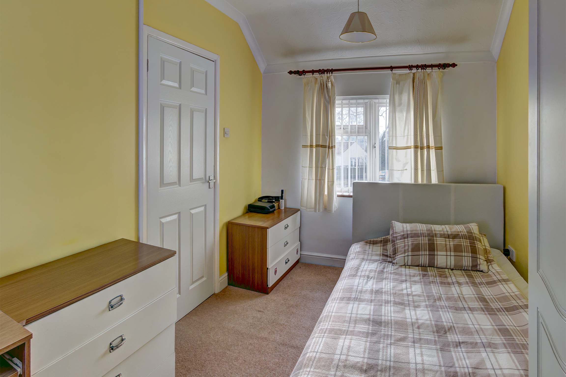 Bedroom with bed and chest of drawers