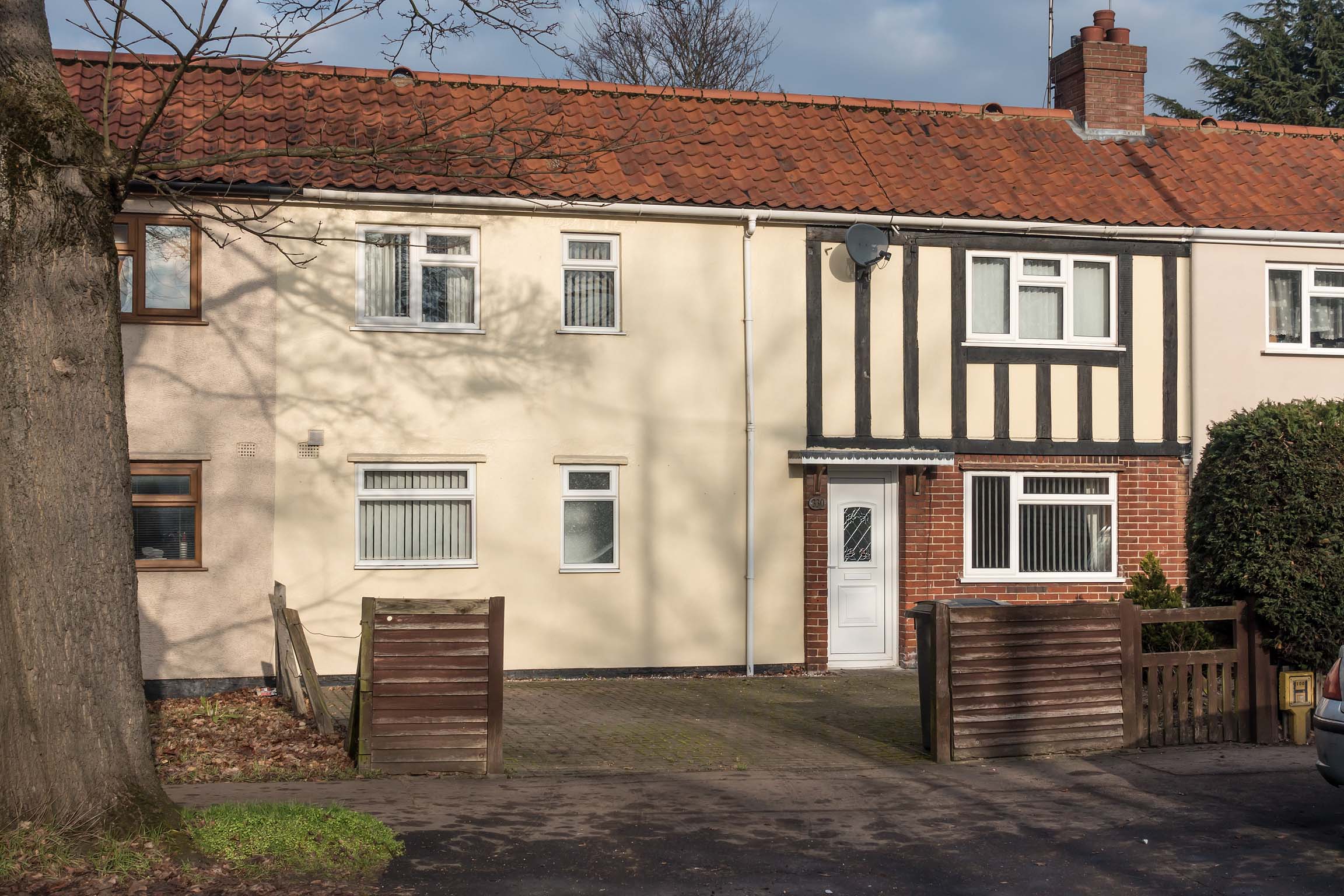 Cream house with driveway