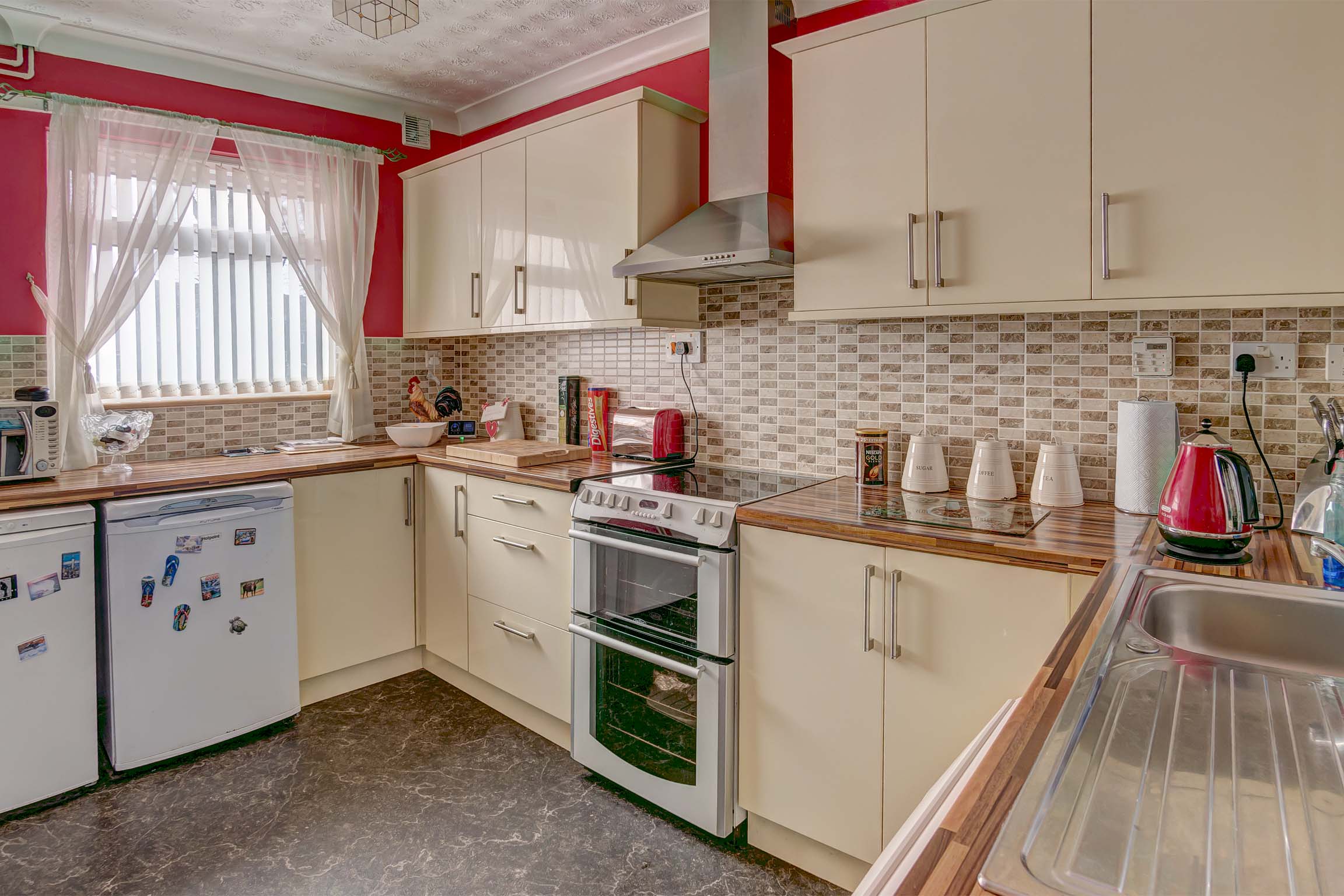 Kitchen with white gloss effect cupboards