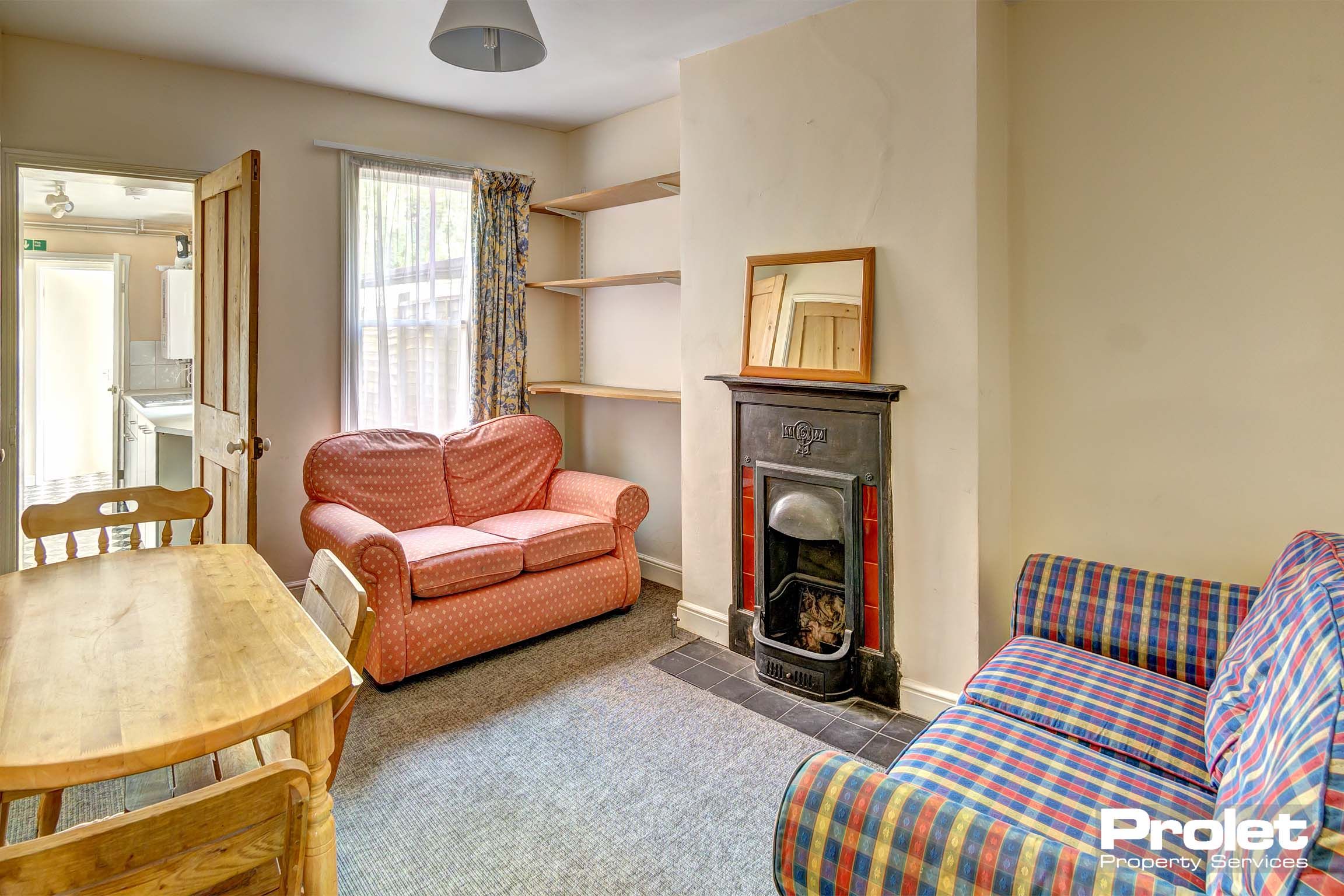 Living room with period fire place and sofas