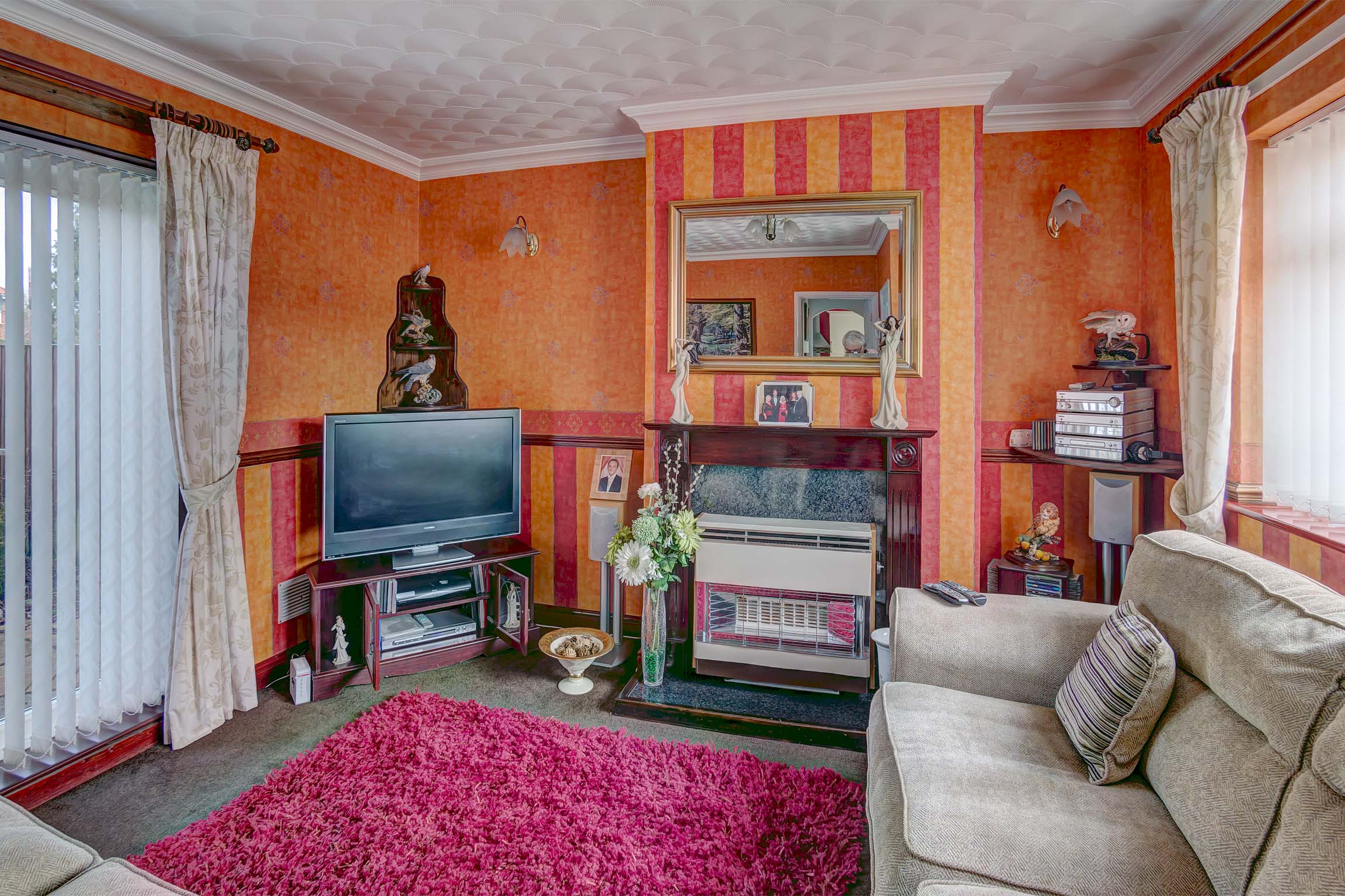 Living room, orange walls and white sofa