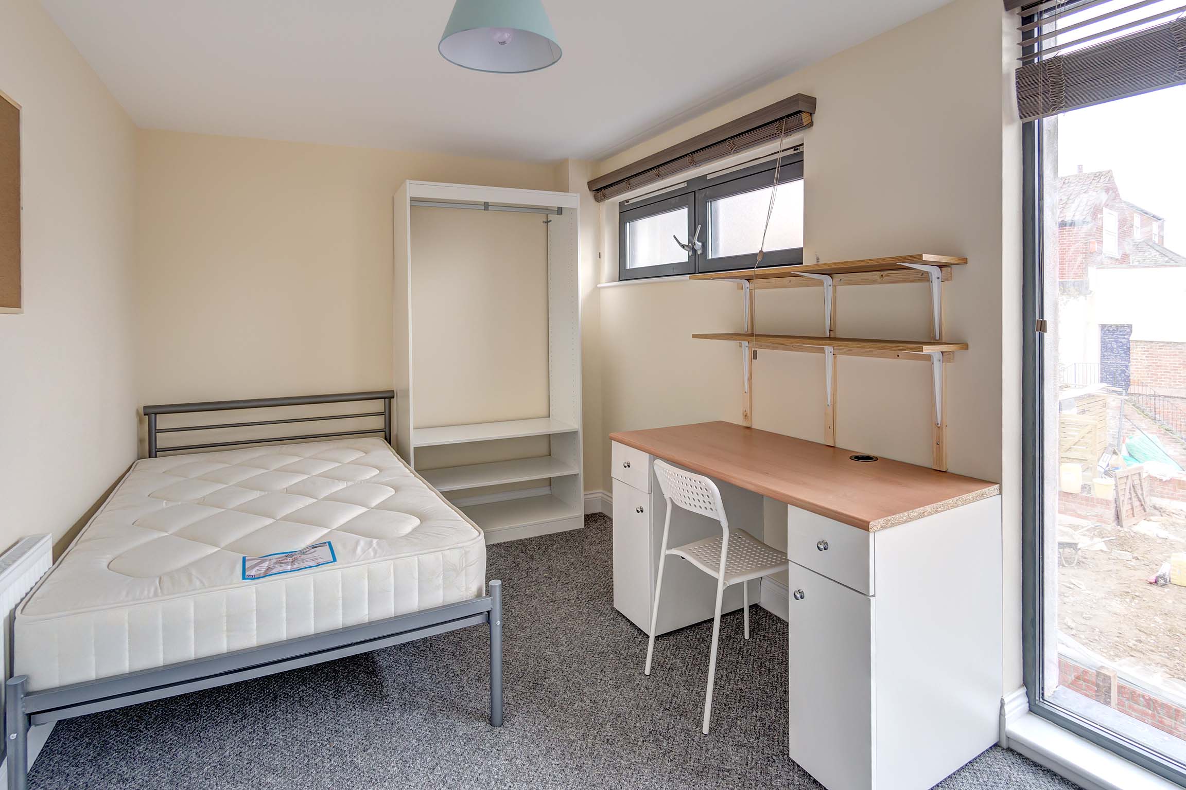 Bedroom with wooden desks and wardrobe