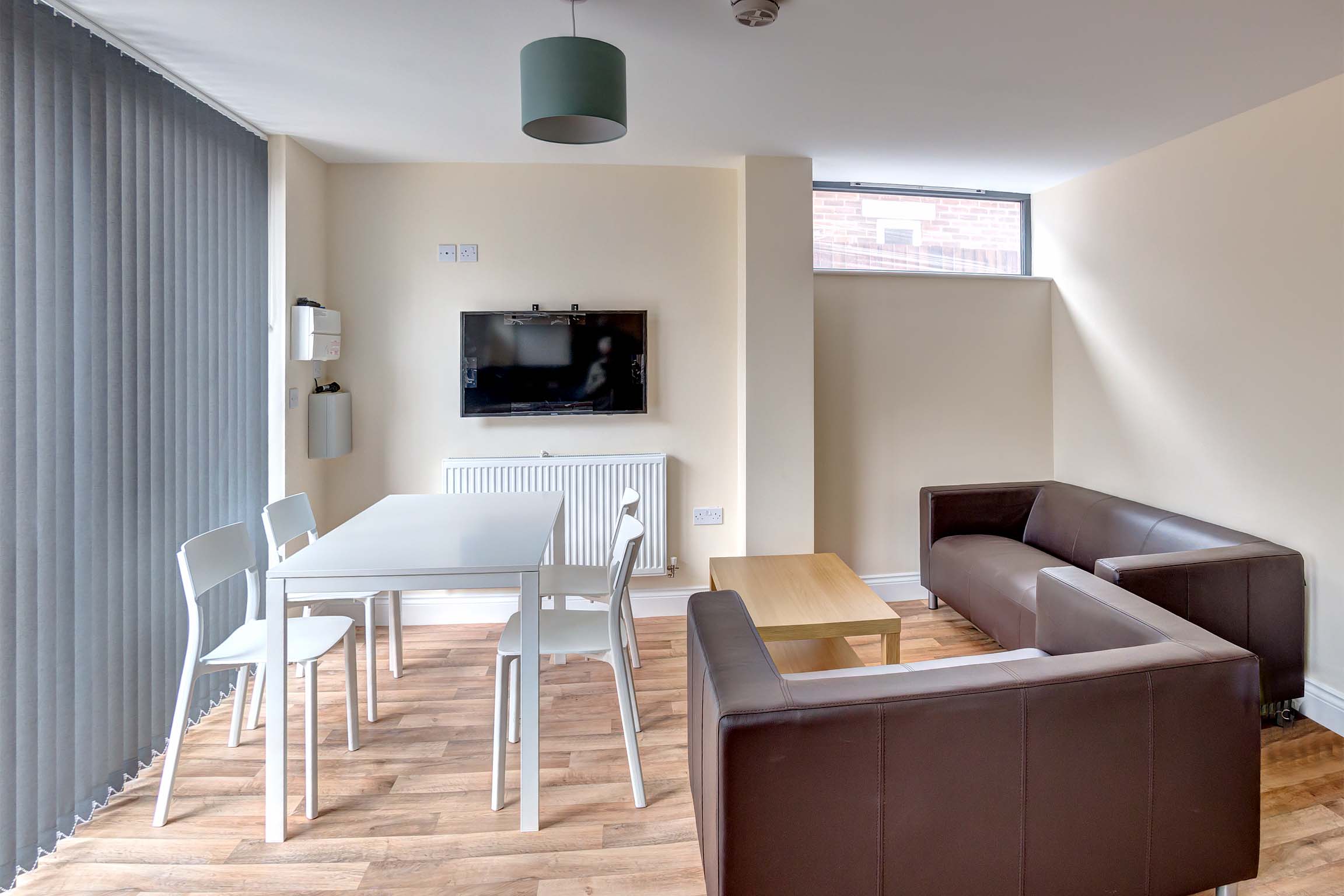 White dining table with TV and sofa