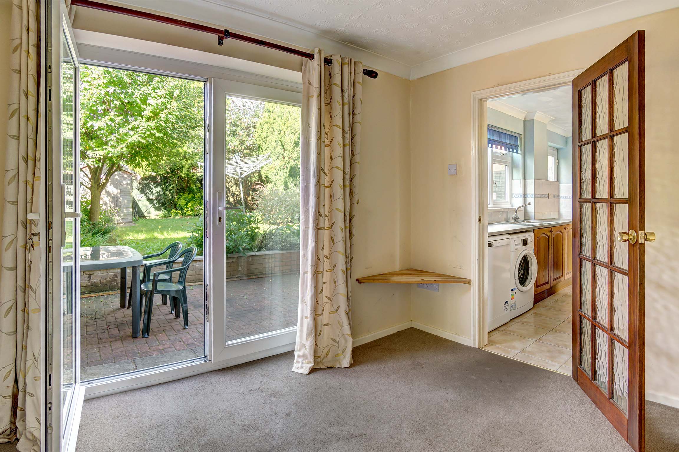 Dining area with magnolia walls. Patio doors into the rear garden.