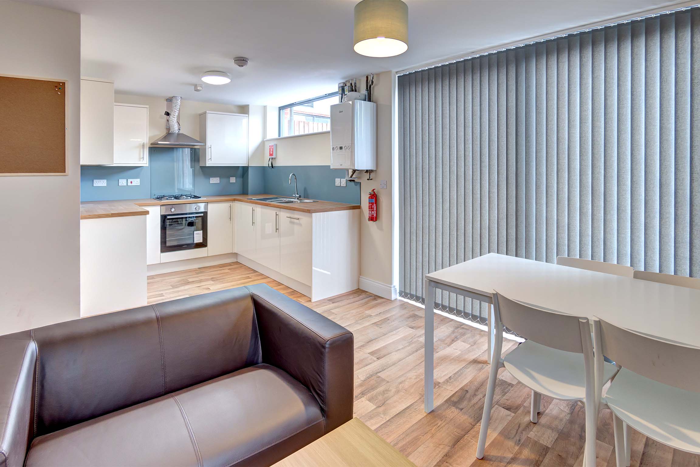 White fitted kitchen with dining table