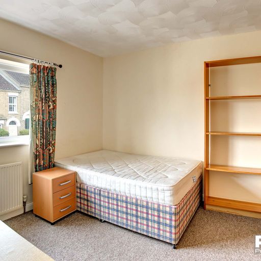 Bedroom with double bed and wood furnishings