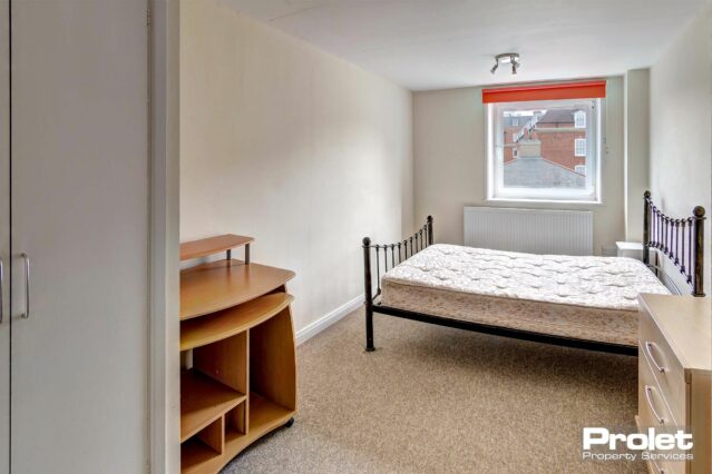 Bedroom with double bed and wooden desk