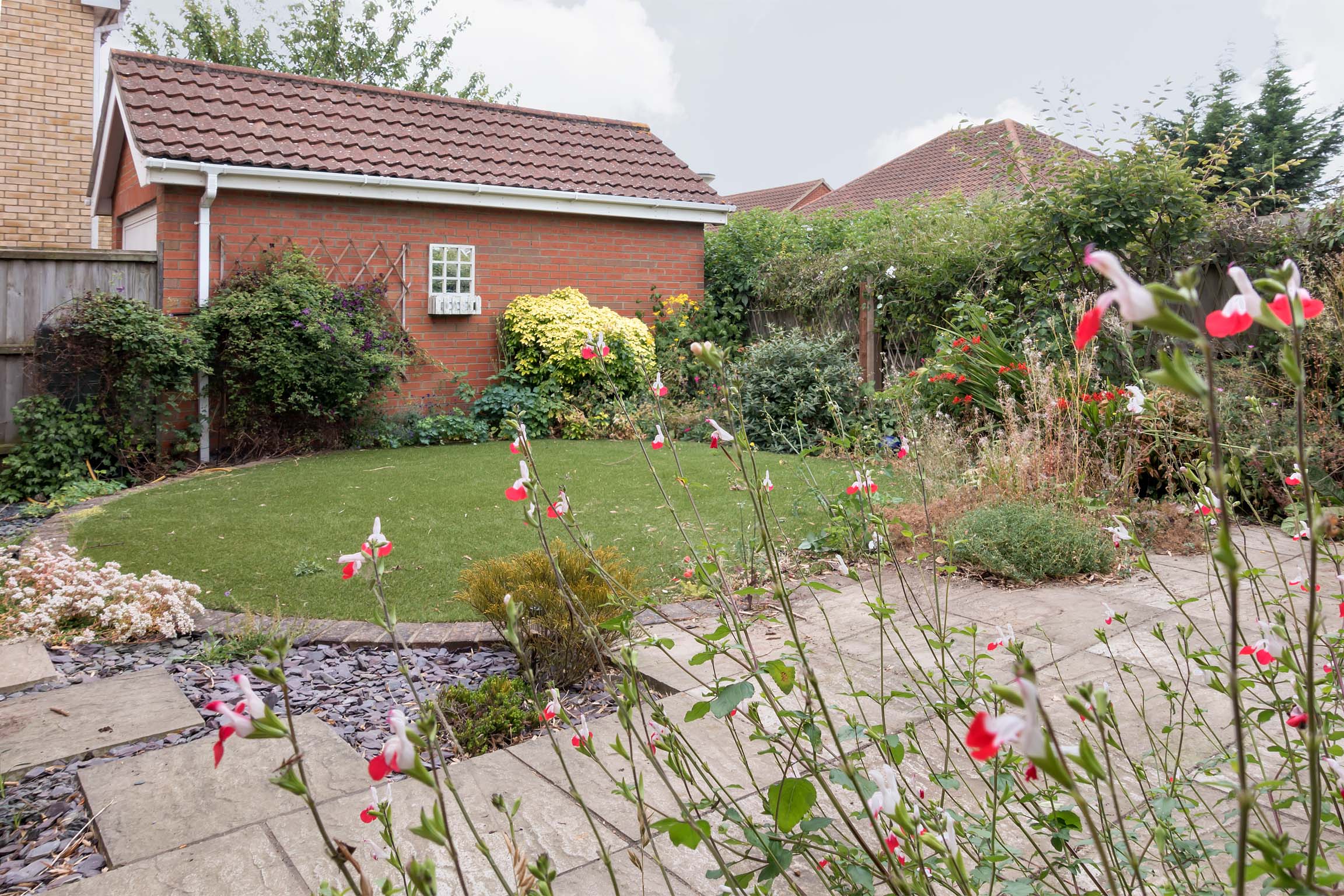 Grass area at rear of property with flowers.