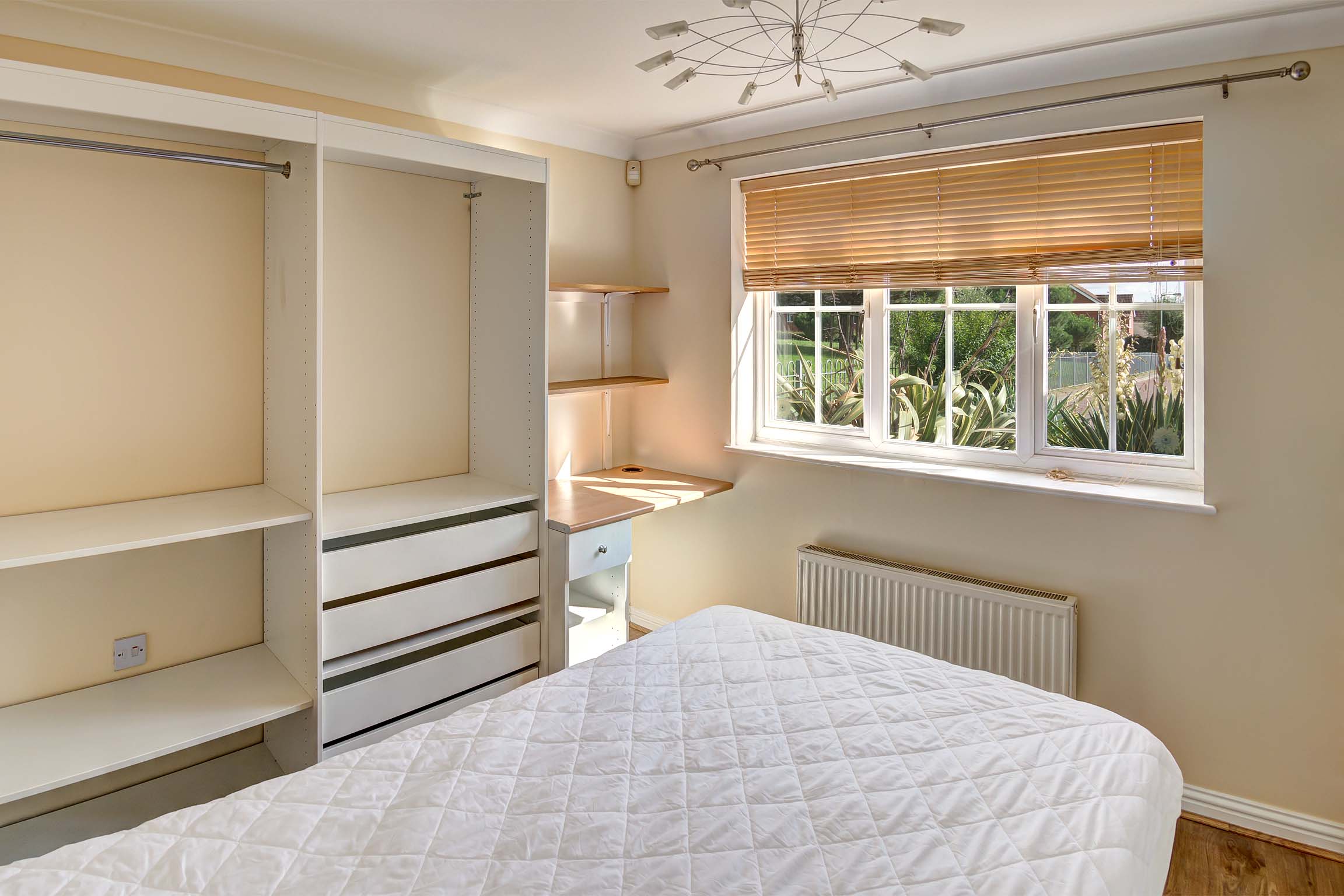 Bedroom with storage space and wooden effect desk