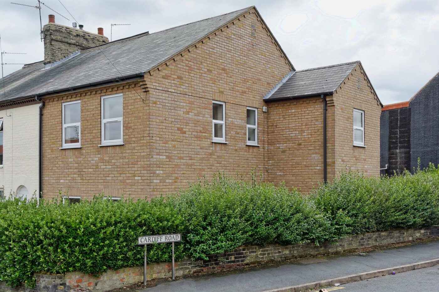 End of terrace house surrounded by hedging