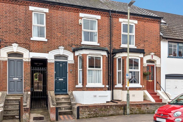 Brick terraced house with blue door