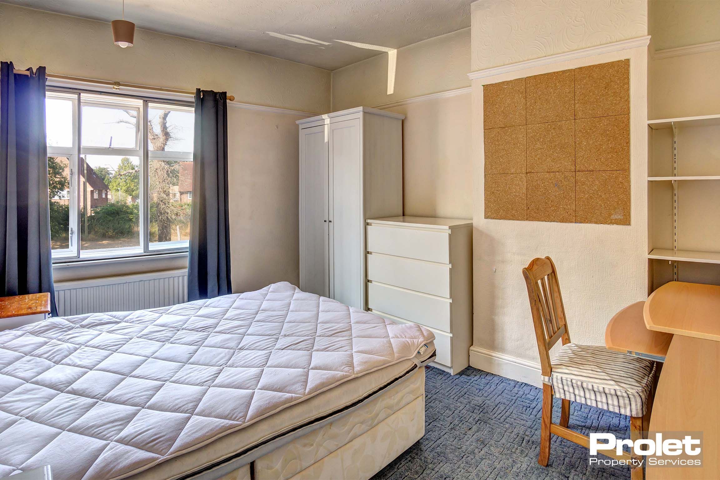 Bedroom with double bed and white furnishings