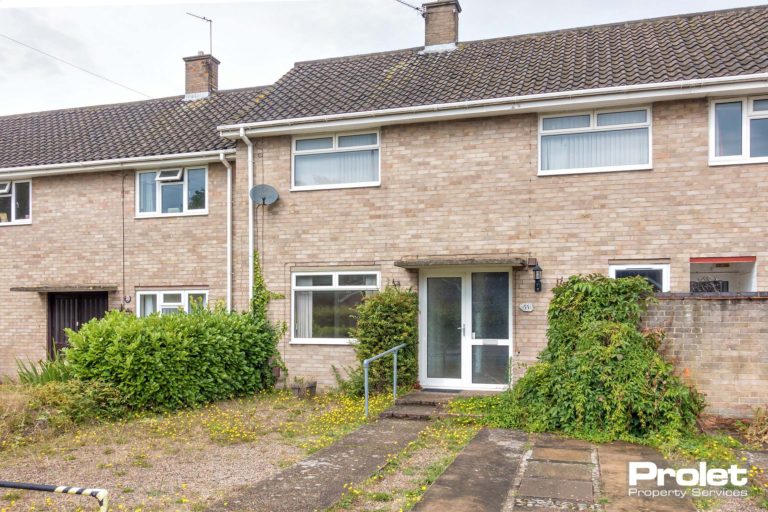 Brick terraced house with porch over door.