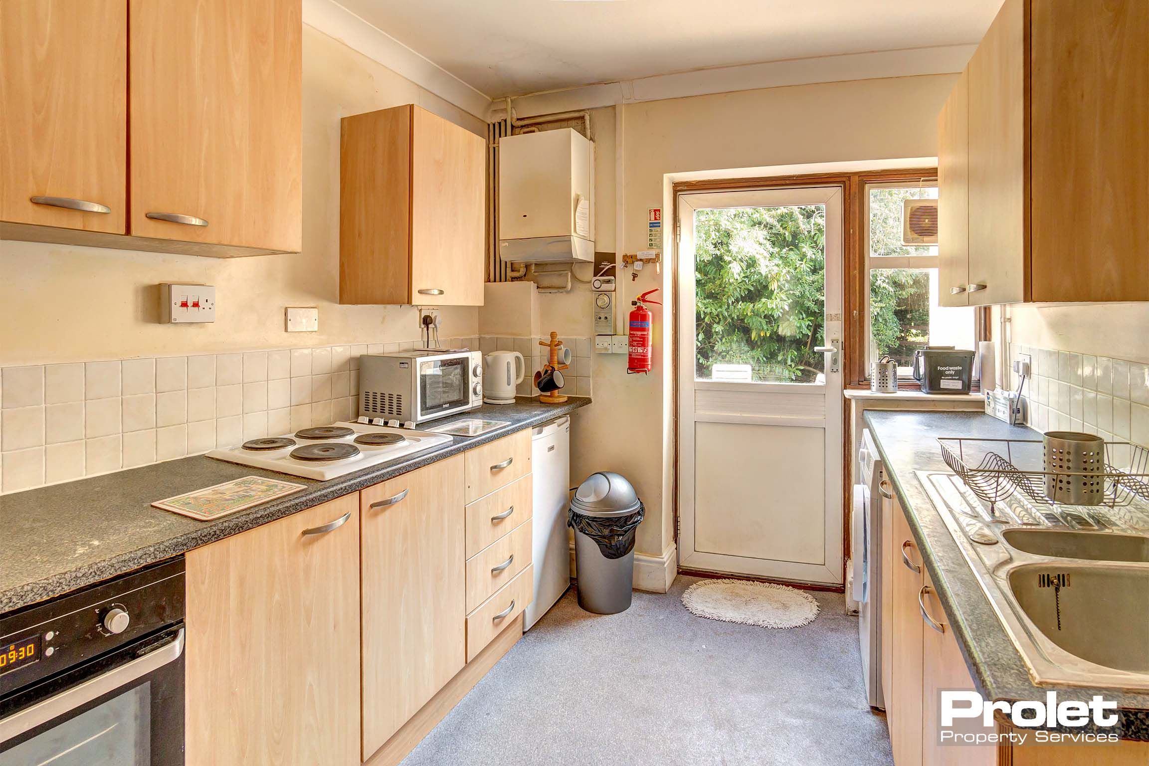 Galley style kitchen with wood effect cabinets