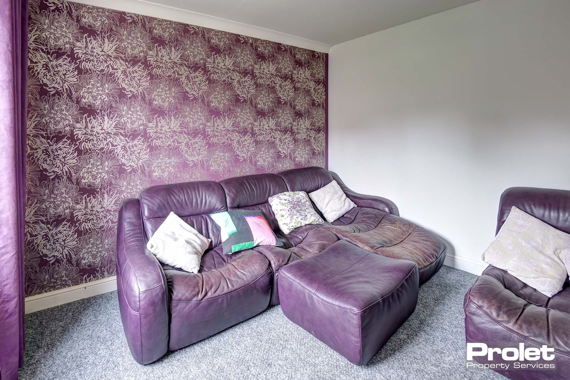 Lounge with purple leather sofa