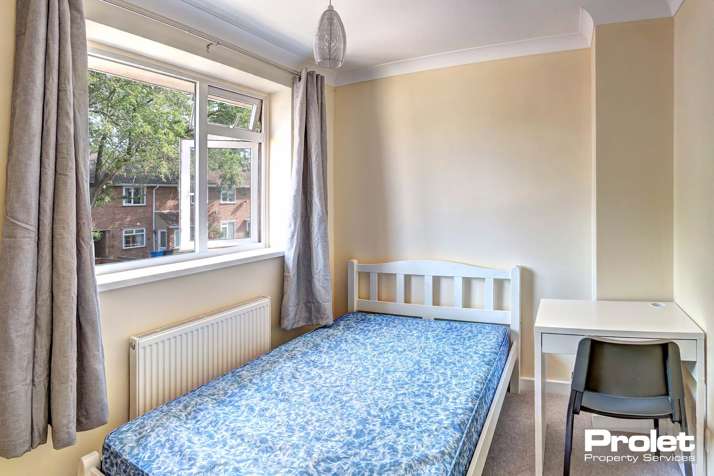 Bedroom with double bed and desk