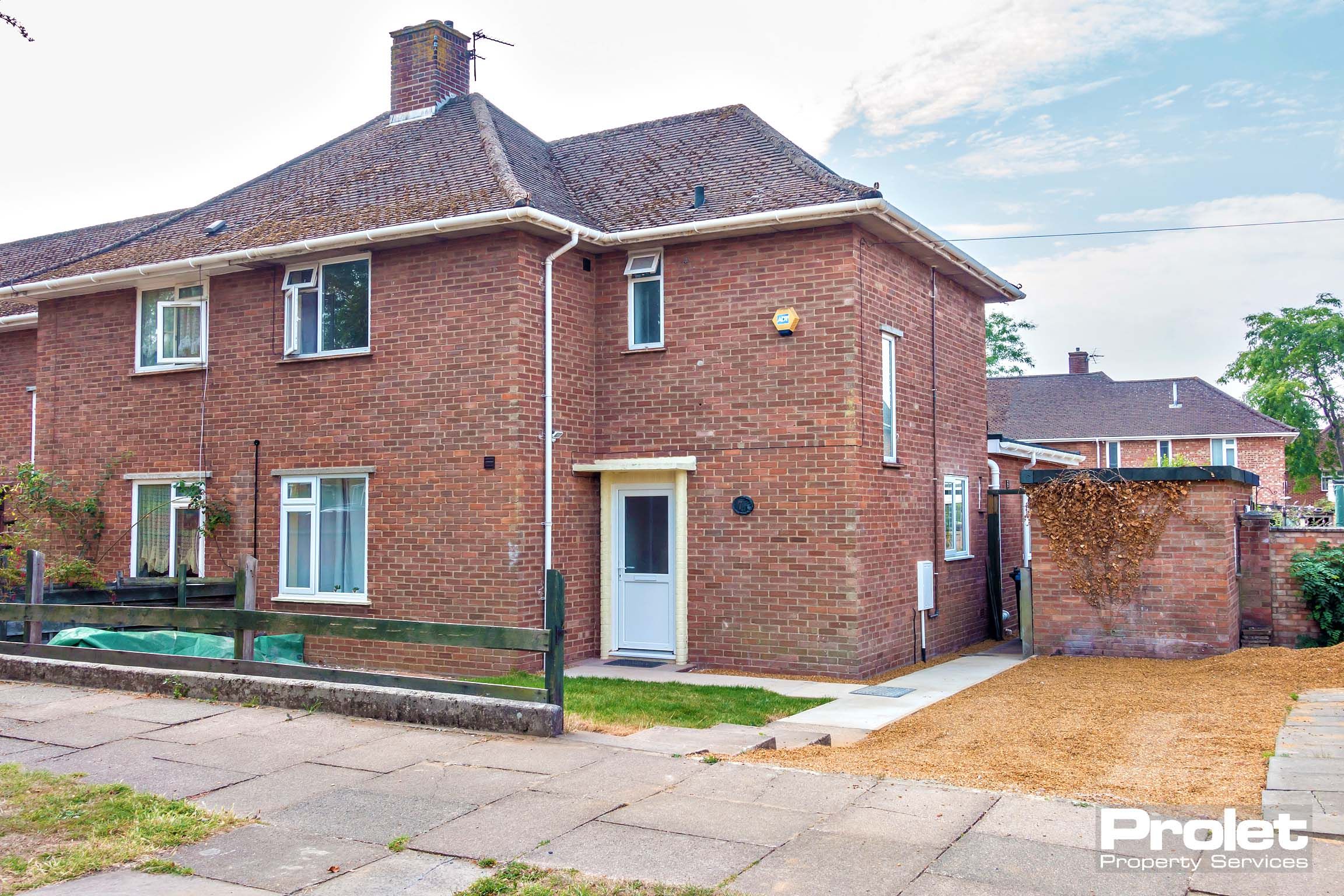 Red brick house with driveway