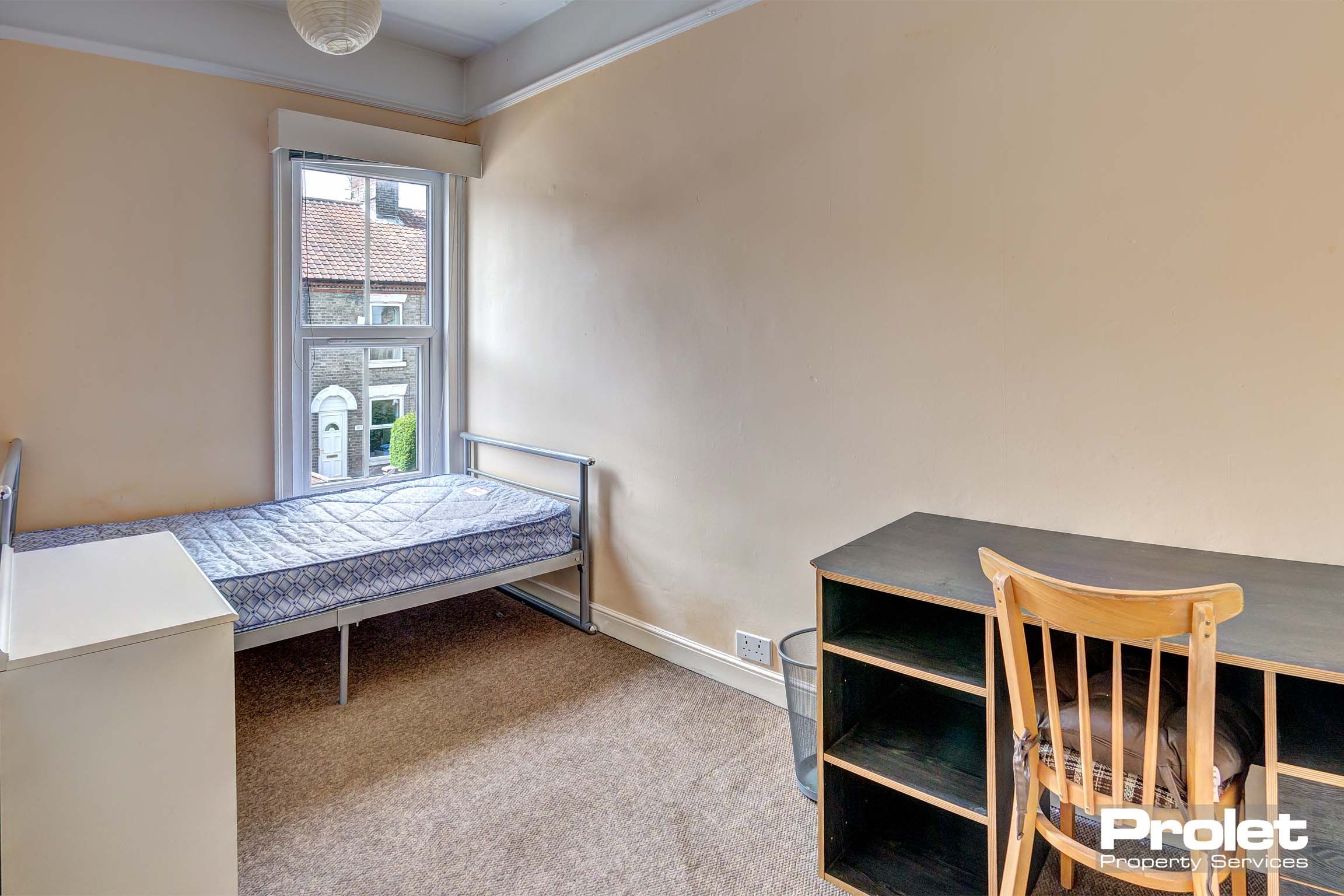 Bedroom with double bed and desk