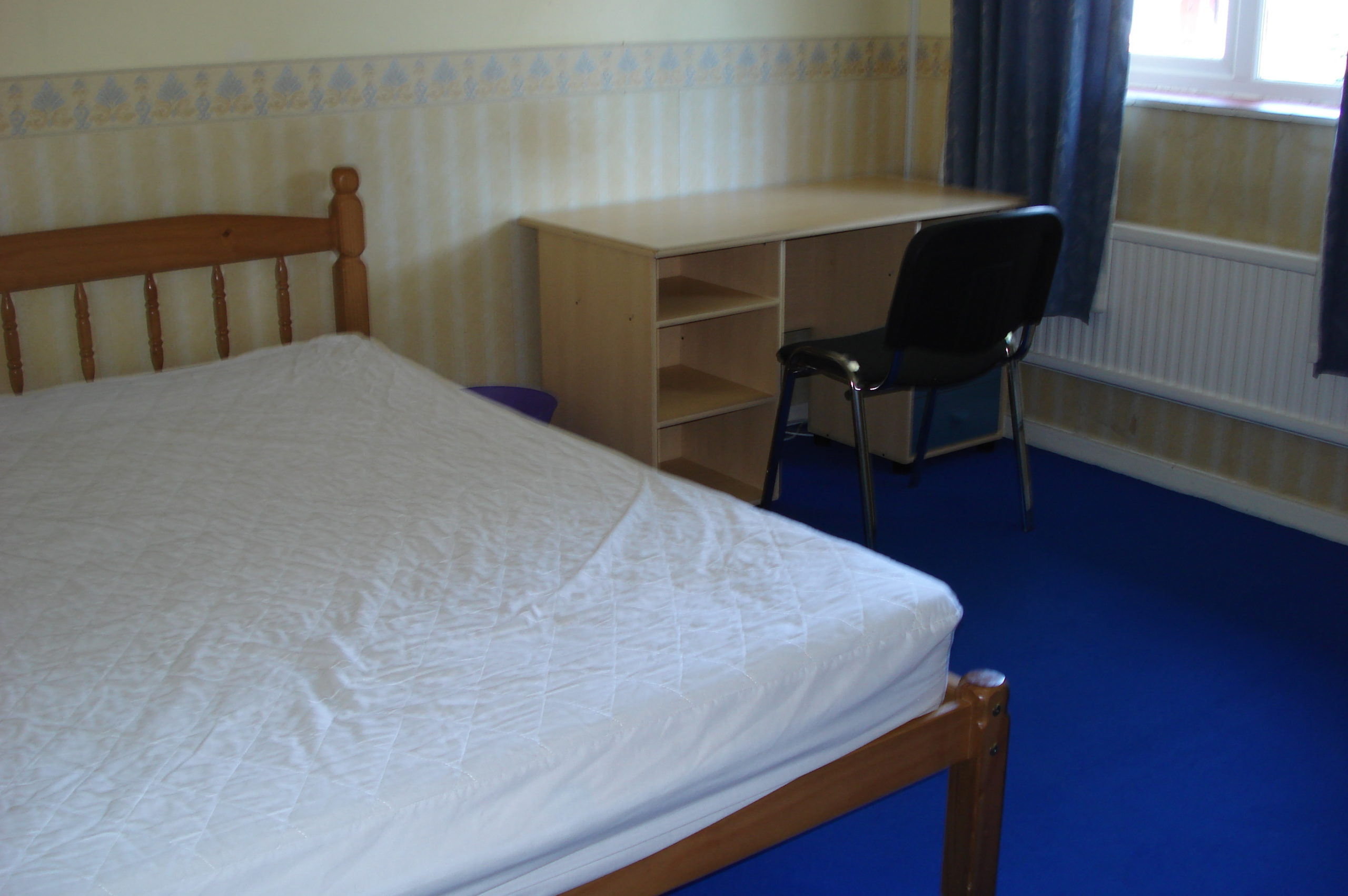 Bedroom with double bed and wooden furnishings