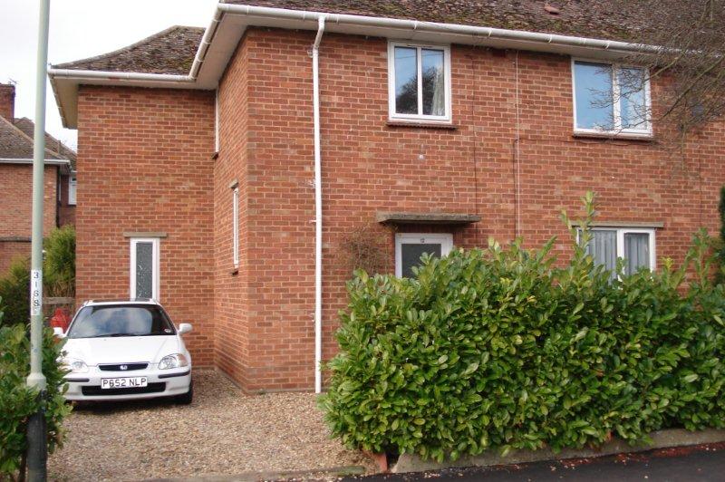 Red brick semi-detached house with large driveway