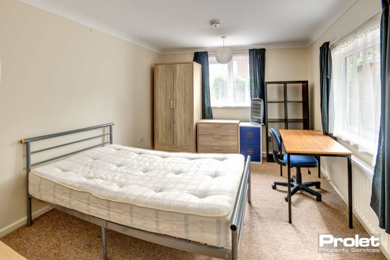 Bedroom with desk and storage