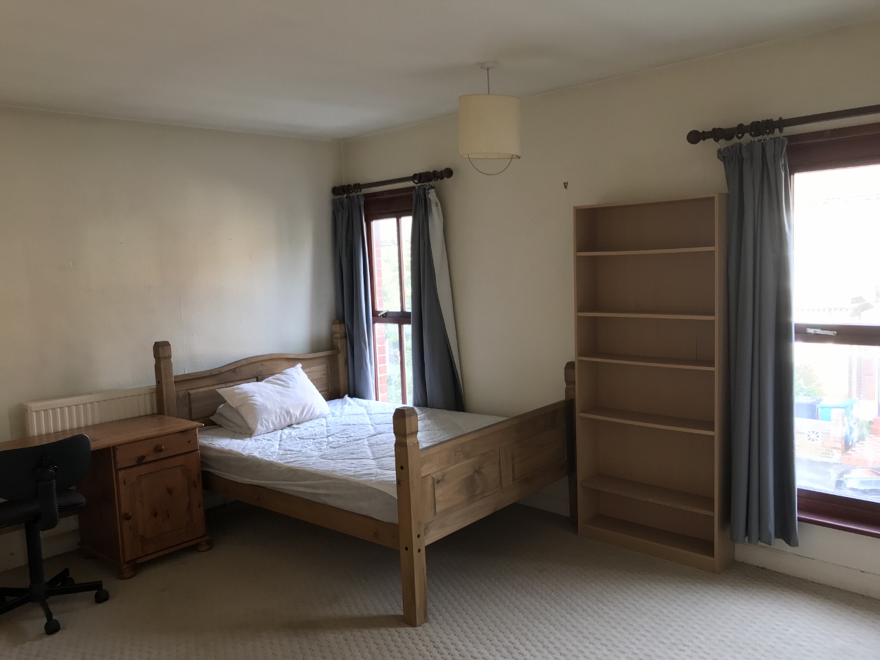 Bedroom with double bed and wooden furnishings