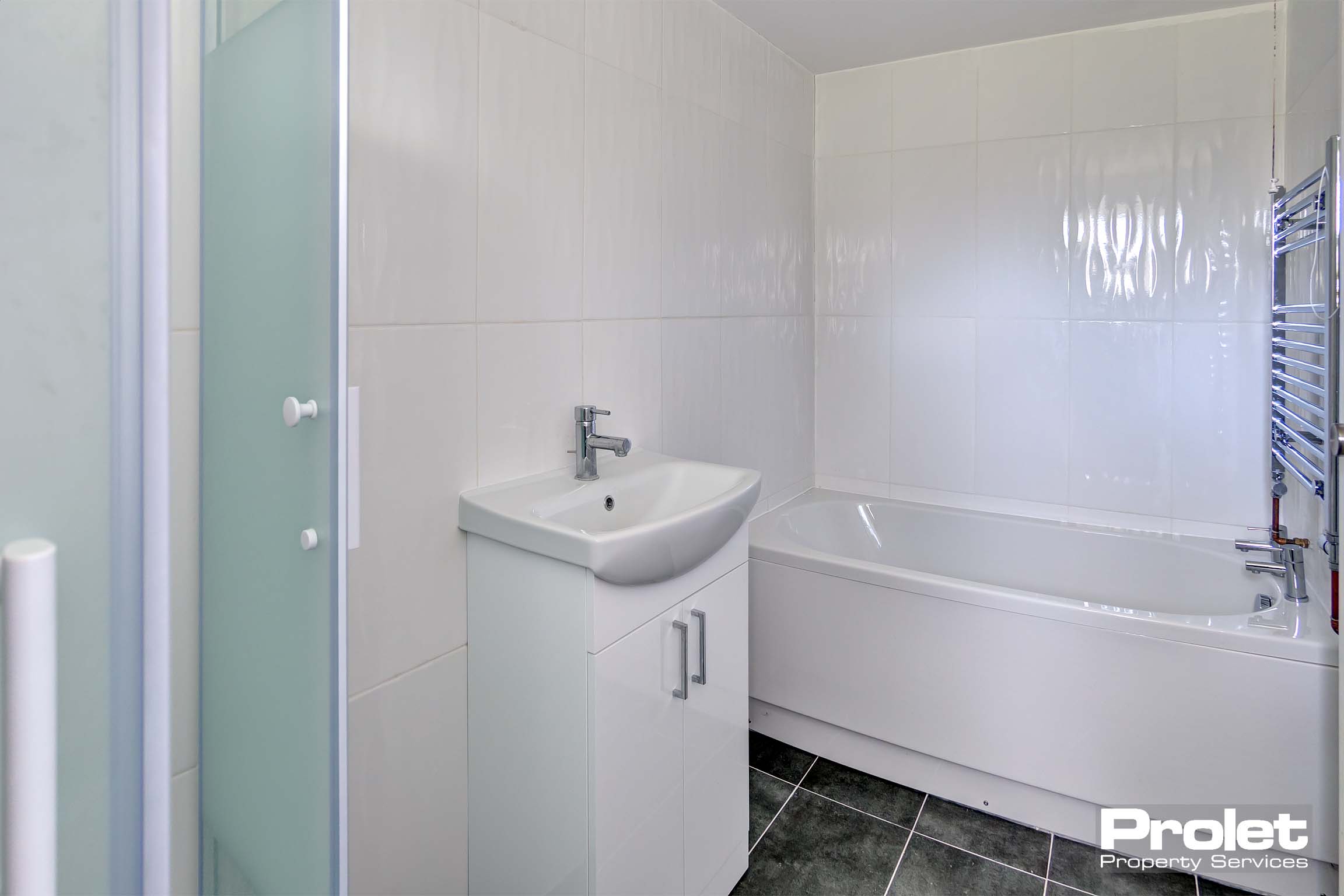 Bathroom with shower cubicle, sink, and bath