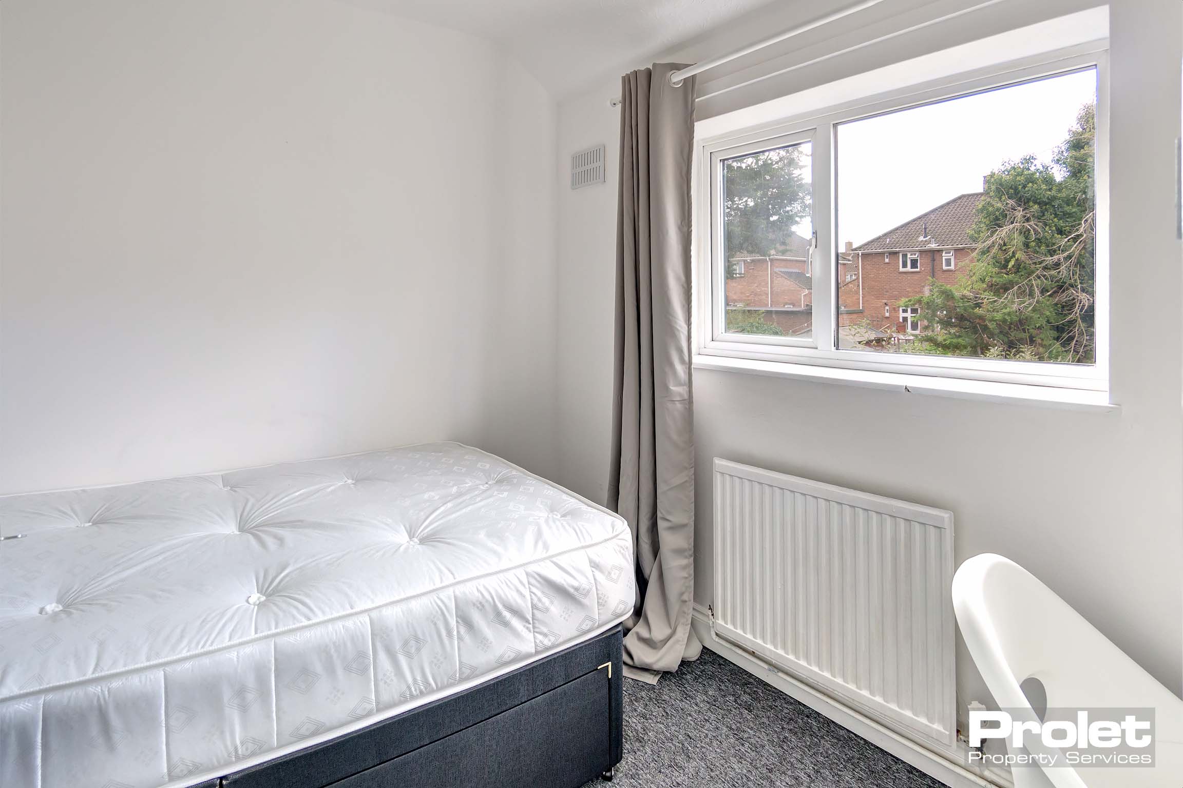 Bedroom with double bed and desk