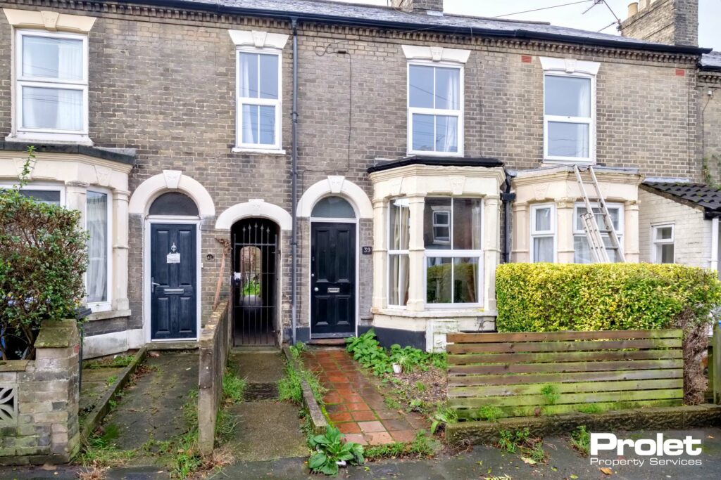 Terraced house with bay window and black front door