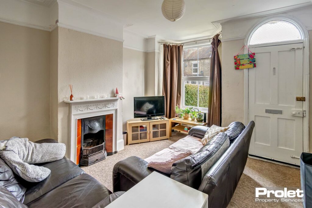 Large living room with period fireplace and sofas