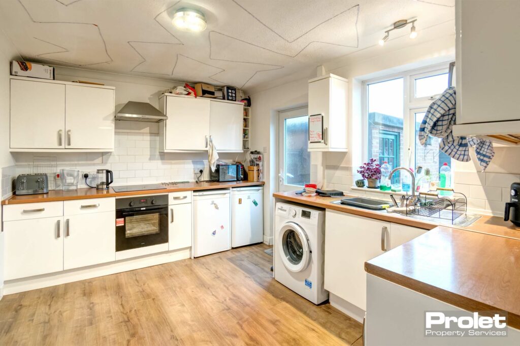 Modern kitchen with white cabinets and white goods