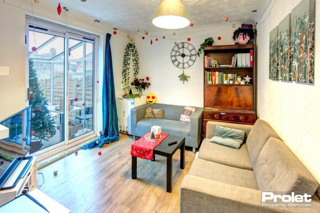 Living room with sofas, coffee table, and shelving